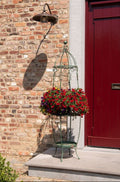 Green brown metal plant stand styled with plants